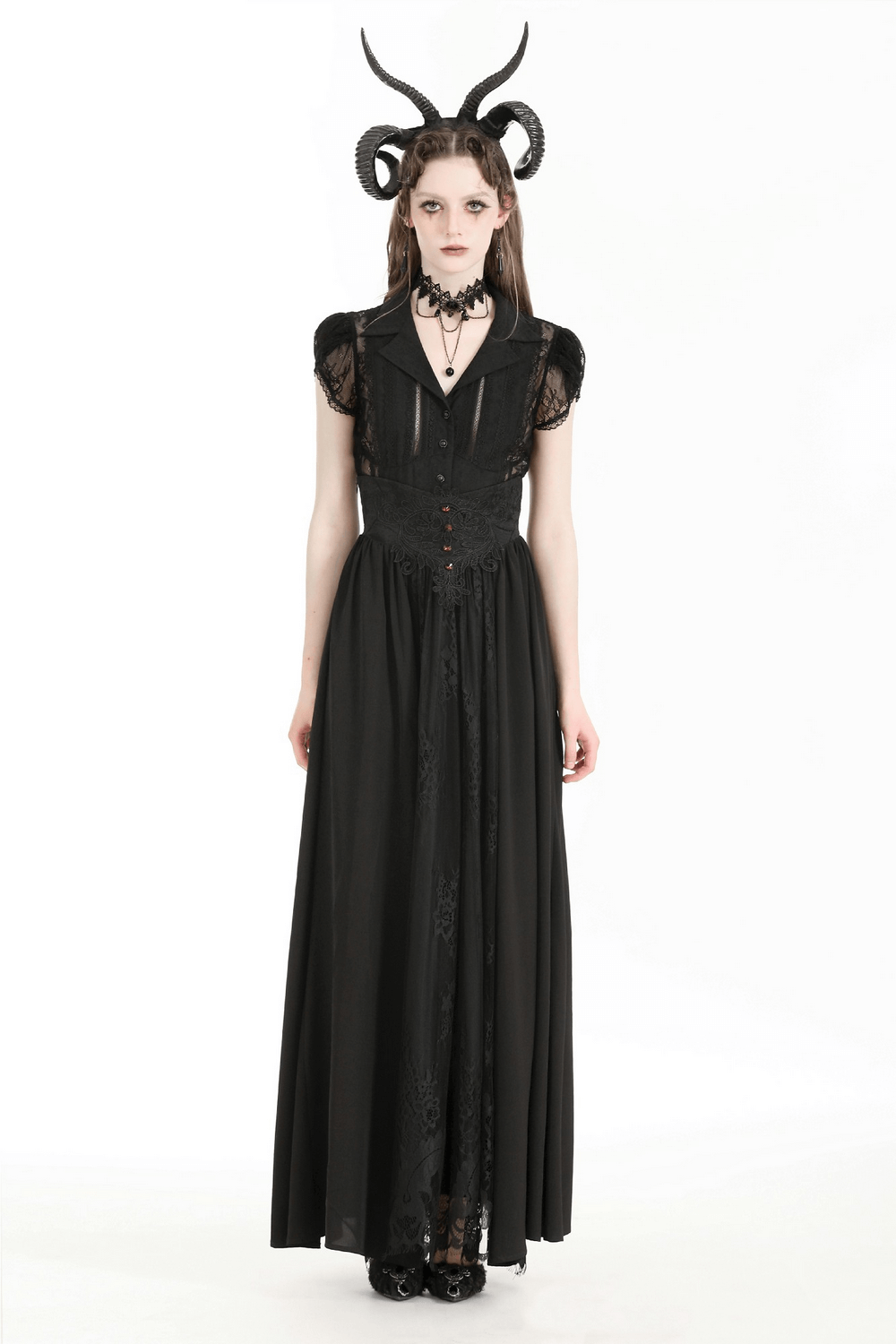 Ethereal woman in a black lace blouse with puff sleeves and gothic accessories, embodying dark elegance.