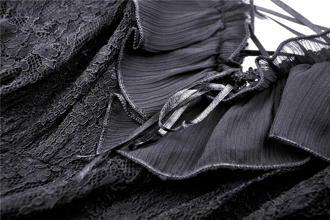 Close-up of black lace off-shoulder dress showcasing delicate floral lace and lace-up detailing, perfect for a gothic look.