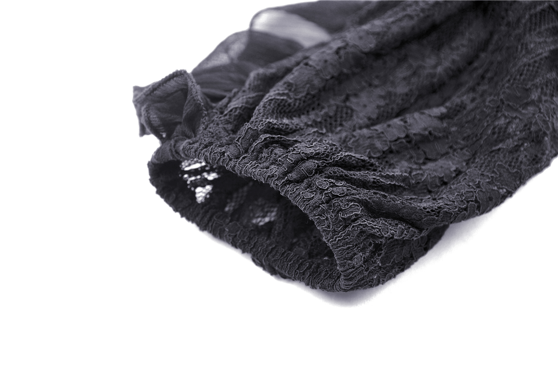 Close-up of delicate black lace sleeve detail on a gothic off-shoulder dress, showcasing intricate floral patterns.