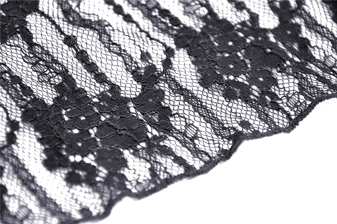 Close-up of intricate black lace fabric showcasing floral patterns, perfect for gothic or witchy garments.