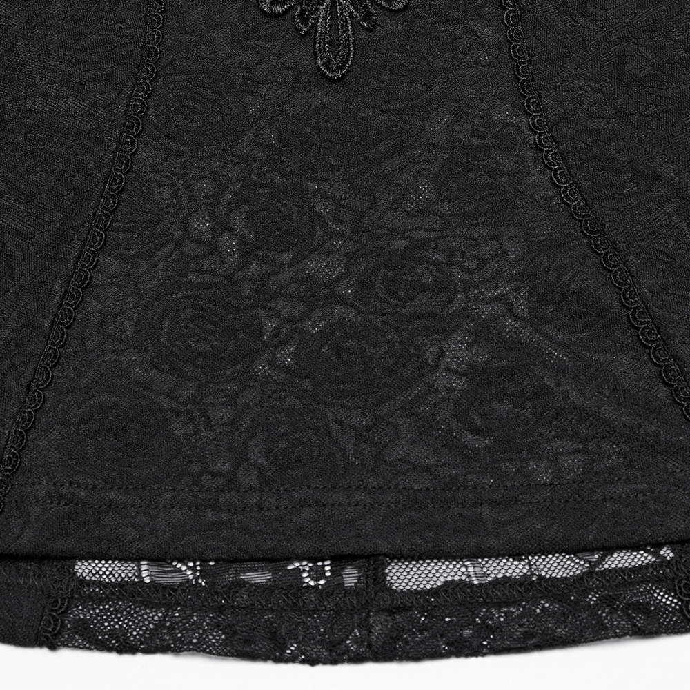 Close-up of women's black lace ruffle top showcasing rose-patterned knit and sheer floral lace detail.