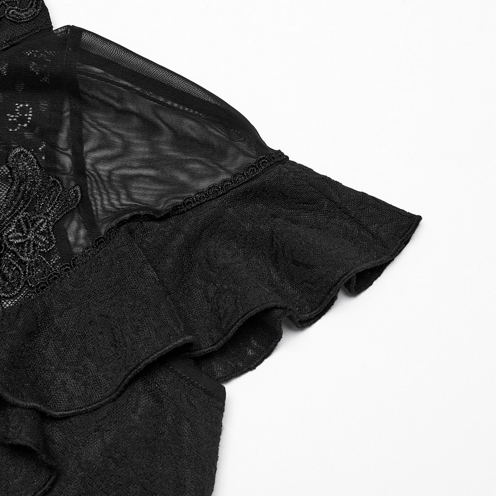 Women's black lace ruffle top with embroidered applique and sheer lace back detail.