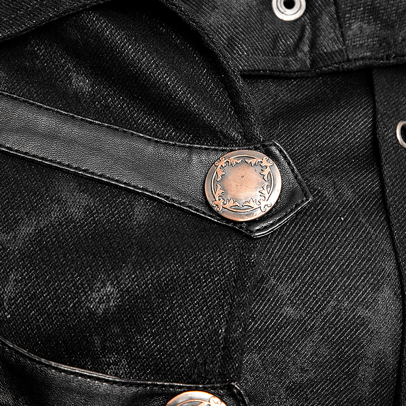 Close-up of the silver button and strap detail on a black gothic trench coat for women.
