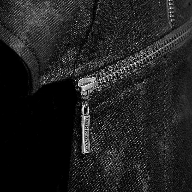 Close-up of a black leather-look coat zipper featuring a silver tag for a gothic fashion statement.