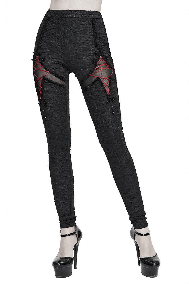 Women's black gothic leggings with red lacings, high-waisted fit, torn inserts, perfect for trendy gothic outfits.