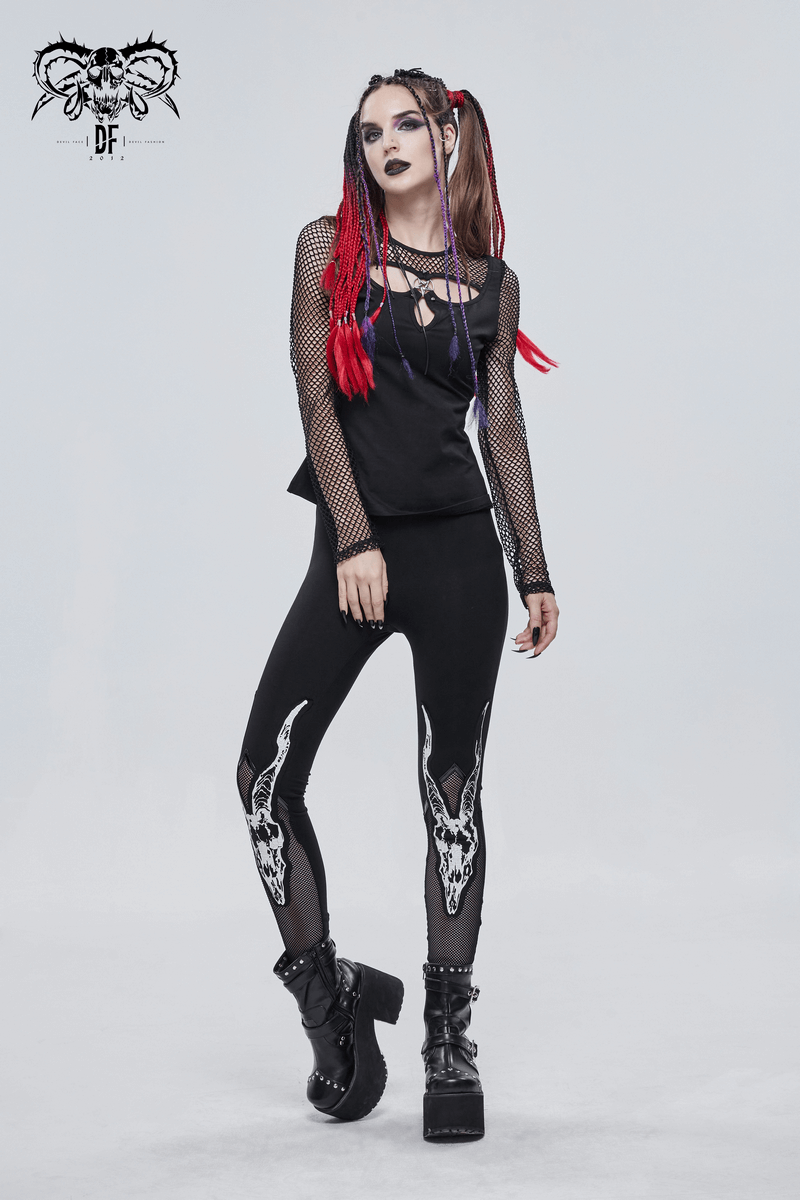 Stylish woman in black punk leggings with white goat skull print and mesh top, showcasing edgy fashion vibes.