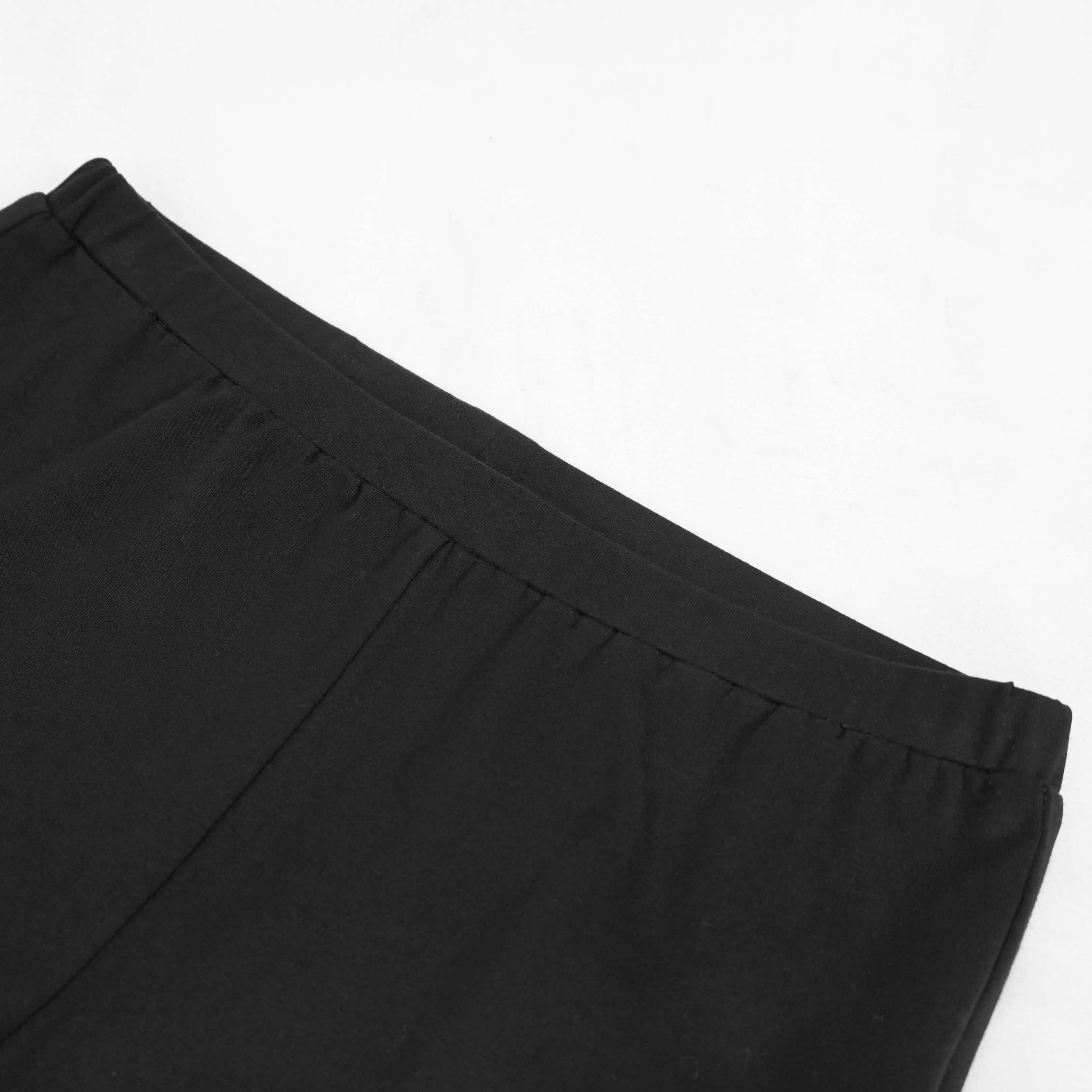Close-up of elastic waistband on stylish black leggings, perfect for punk-inspired outfits.
