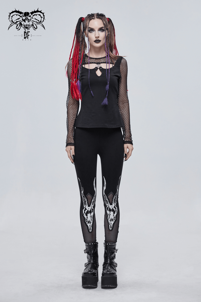 Punk style women in black leggings with white goat skull print and mesh details, showcasing edgy fashion.