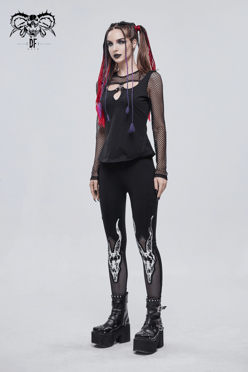 Punk style woman in black leggings with white goat skull print, paired with a mesh top and chunky platform boots.