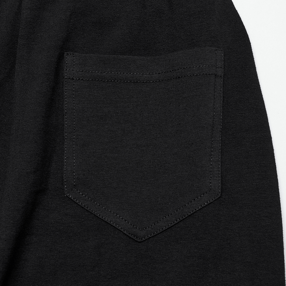 Close-up of the back pocket of women's black ruffle trim flare pants, showcasing a sleek design for Gothic style.