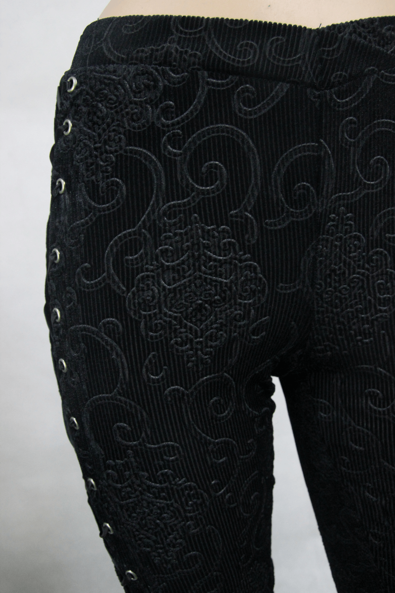 Stylish women's black flared pants featuring intricate lace patterns and lace-up detailing, perfect for a gothic look.