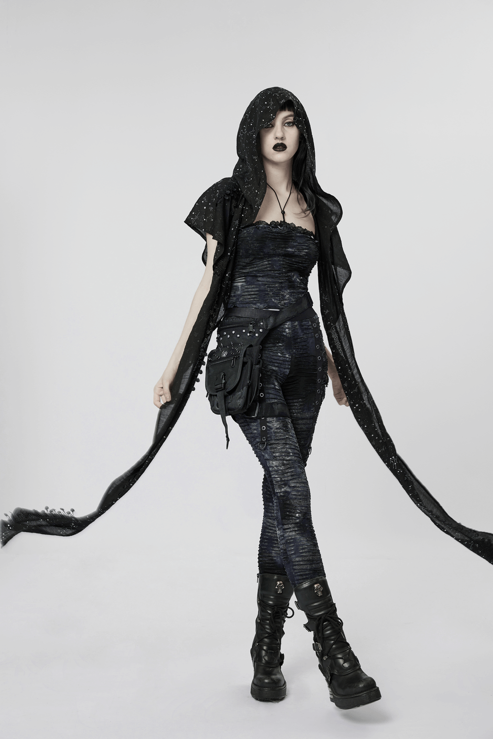 Model wearing a black starry night cape with hood, showcasing a gothic, celestial fashion style.