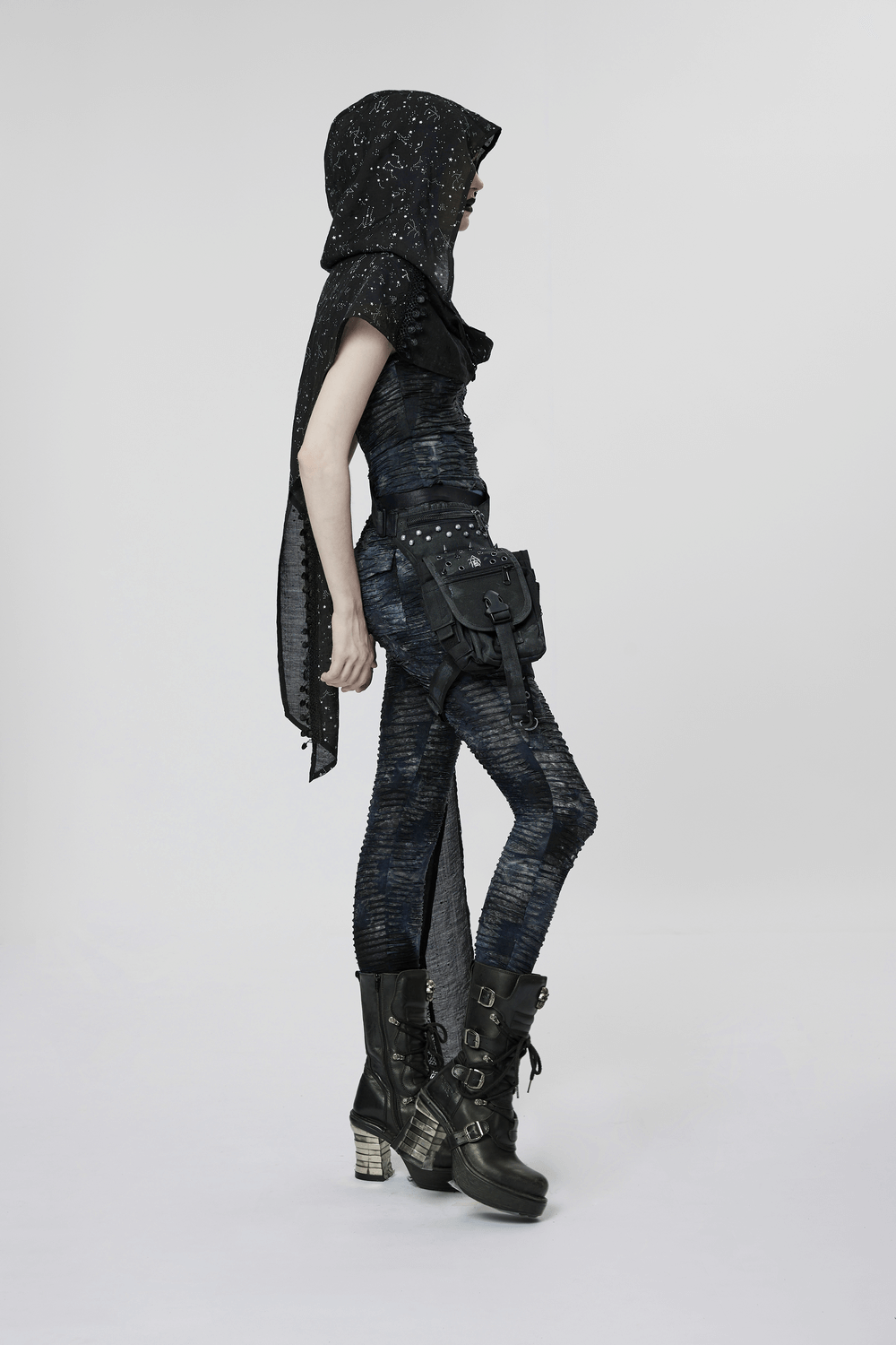Model wearing a women's black starry night hooded cape with tassel lace details, styled with edgy, gothic boots.