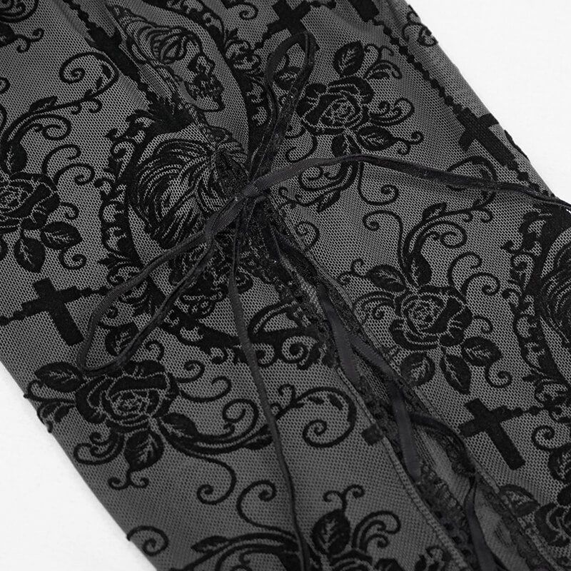 Close-up of elegant black lace-up detail on transparent Gothic leggings with floral patterns.