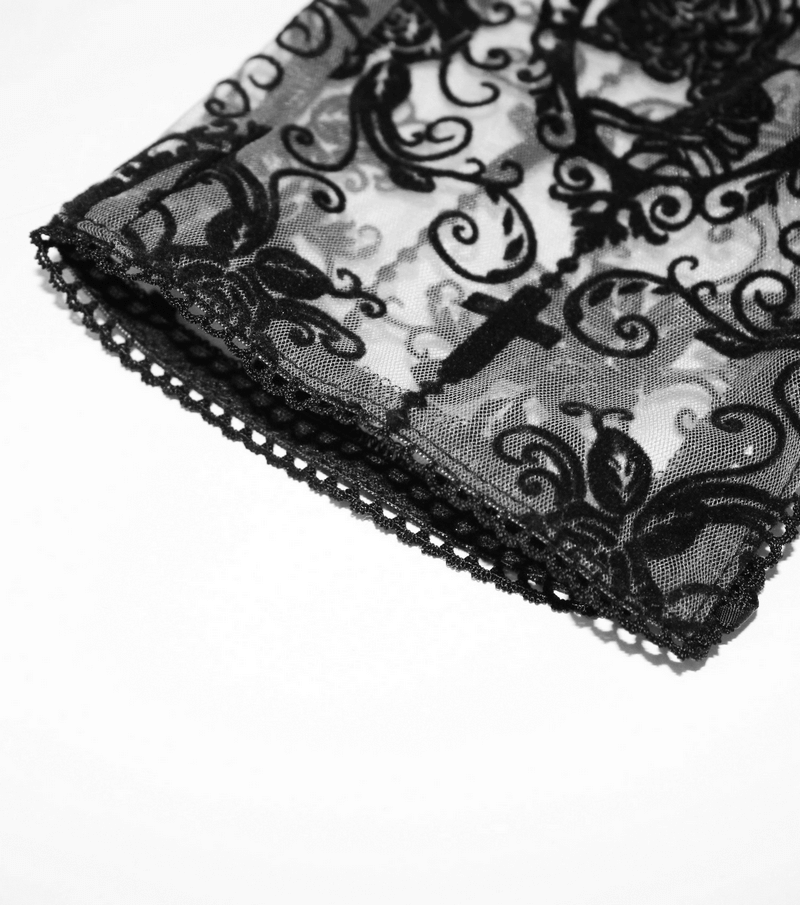 Close-up of intricate black lace with Gothic patterns and cross detail, perfect for stylish leggings.
