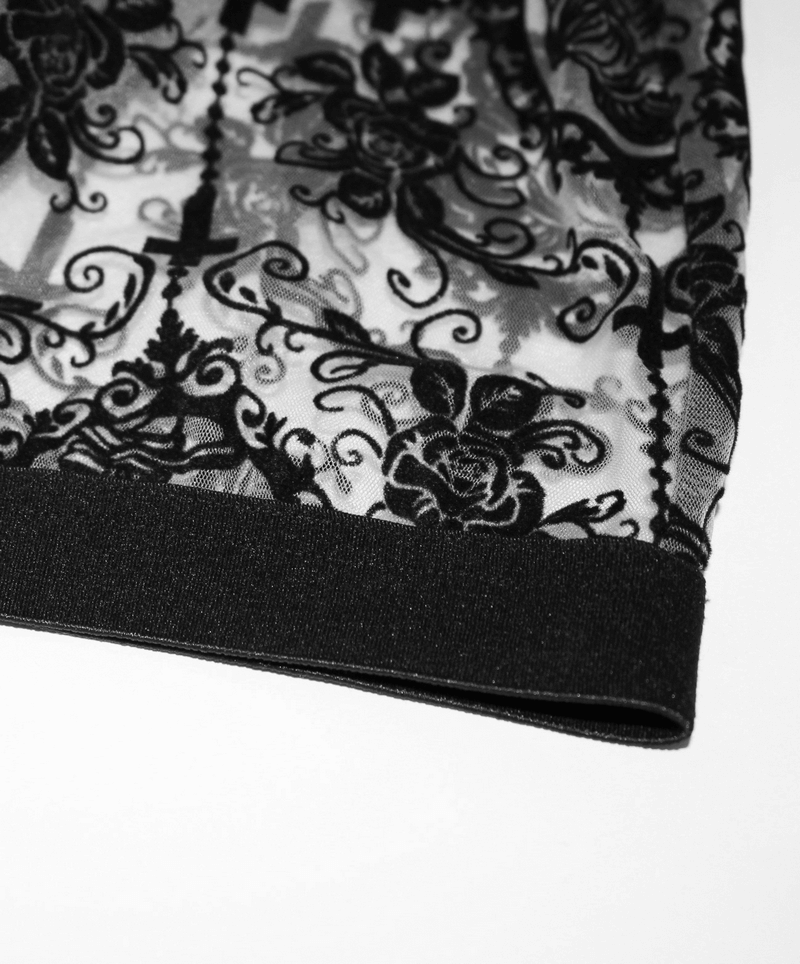 Close-up of elegant black transparent mesh leggings featuring lace and floral design, perfect for gothic style outfits.