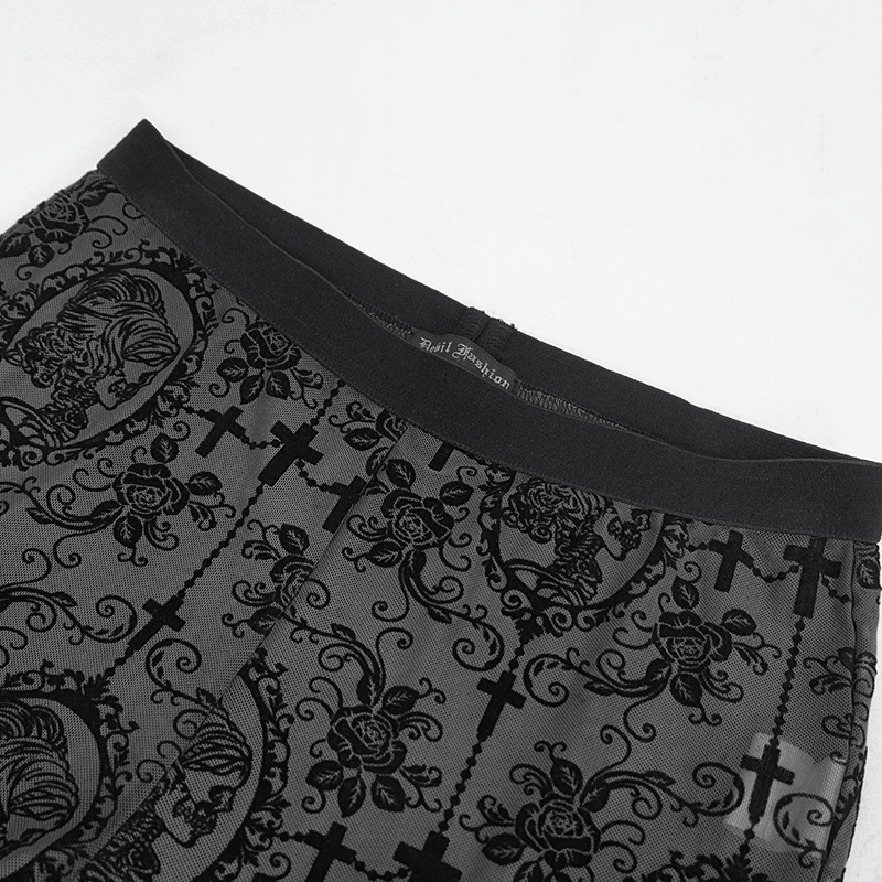 Close-up of elegant gothic women's leggings with intricate black lace and cross patterns, perfect for stylish outfits.