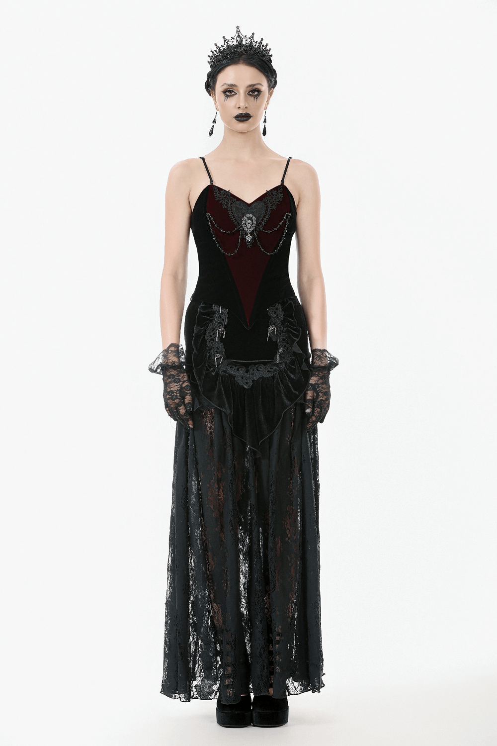 Gothic-inspired woman in black lace and velvet maxi skirt with corset back, adorned with elegant accessories.