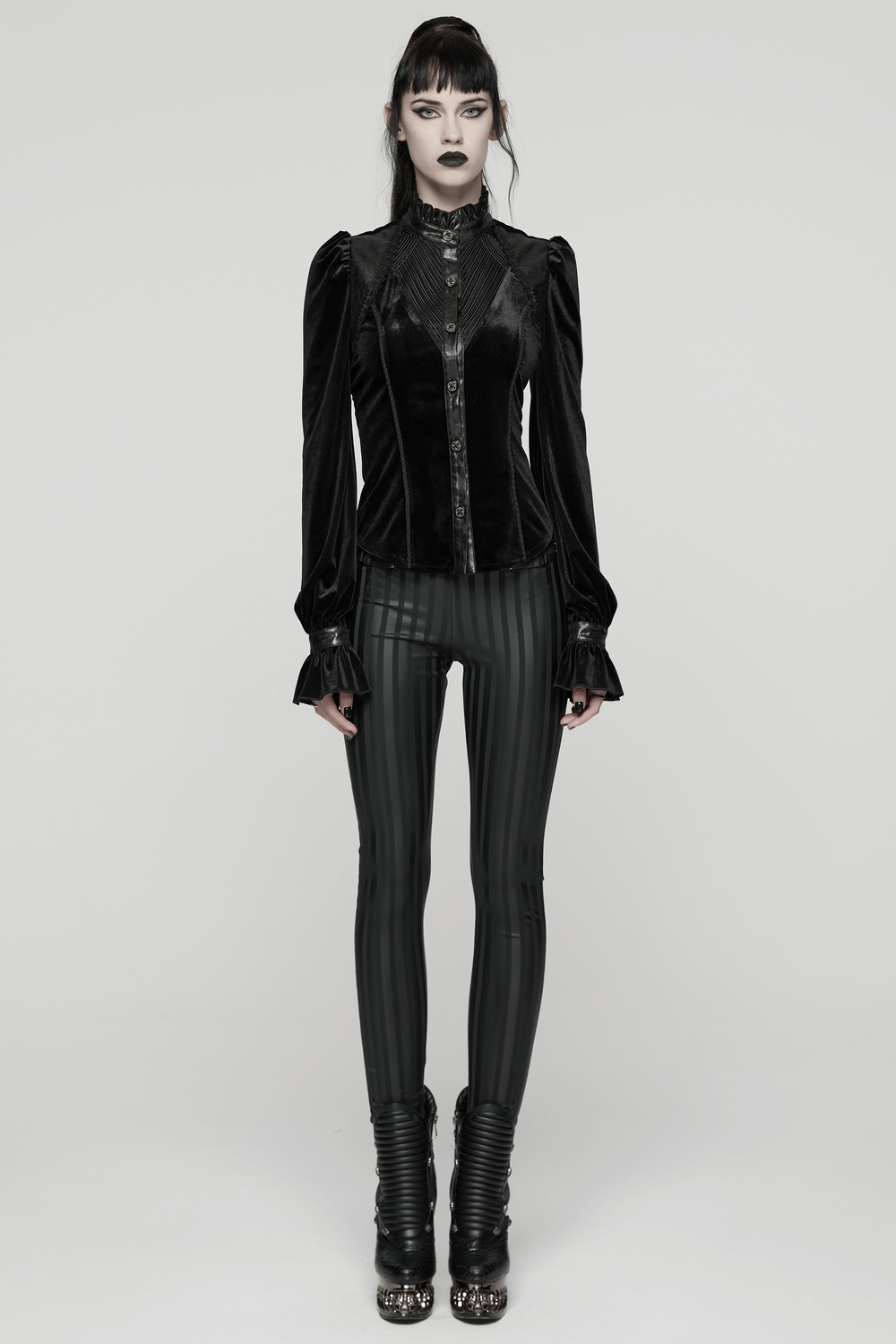 Women's Black Velvet Blouse with Lace Up Back Detail worn with sleek black leggings, showcasing gothic fashion style.
