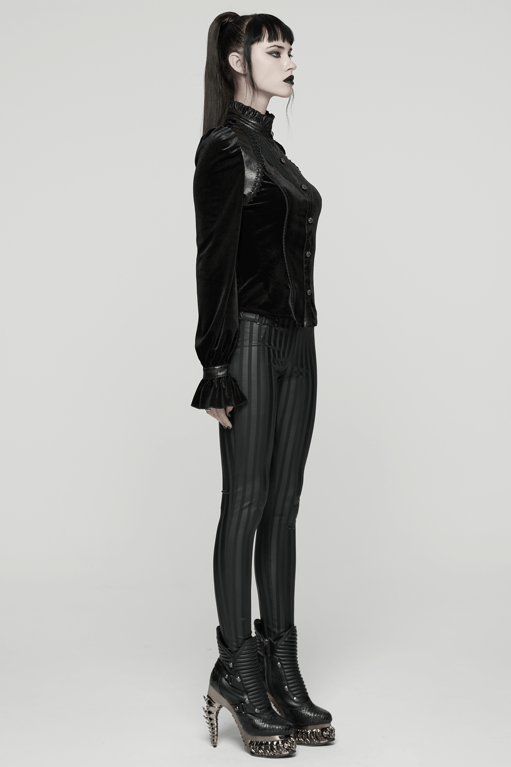 Women's Black Velvet Blouse with Lace Up Back Detail worn with stylish striped pants and edgy boots.