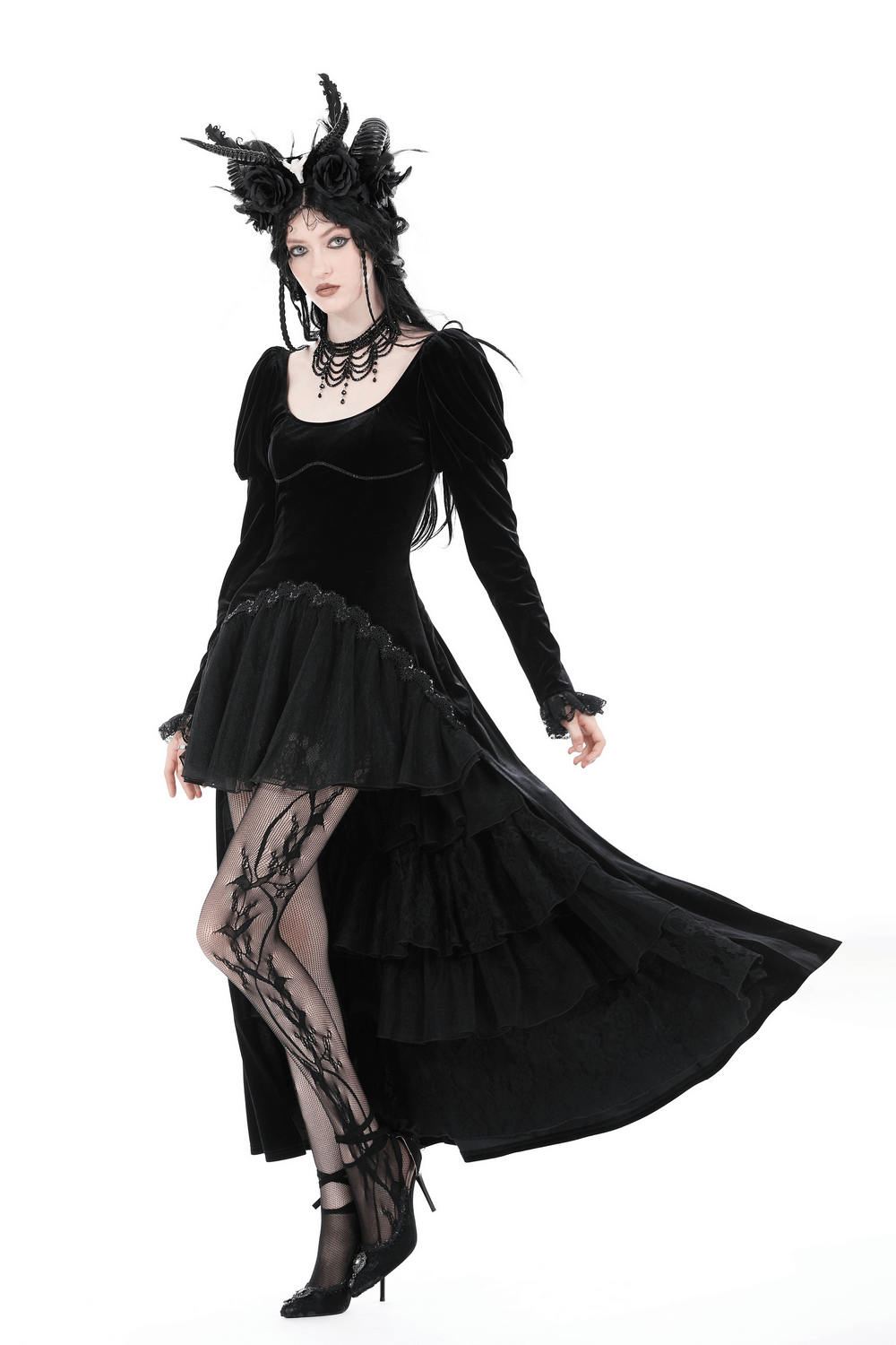 Gothic elegance in a black velvet high-low dress with lace hem, dramatic neckline, and stunning accessories.