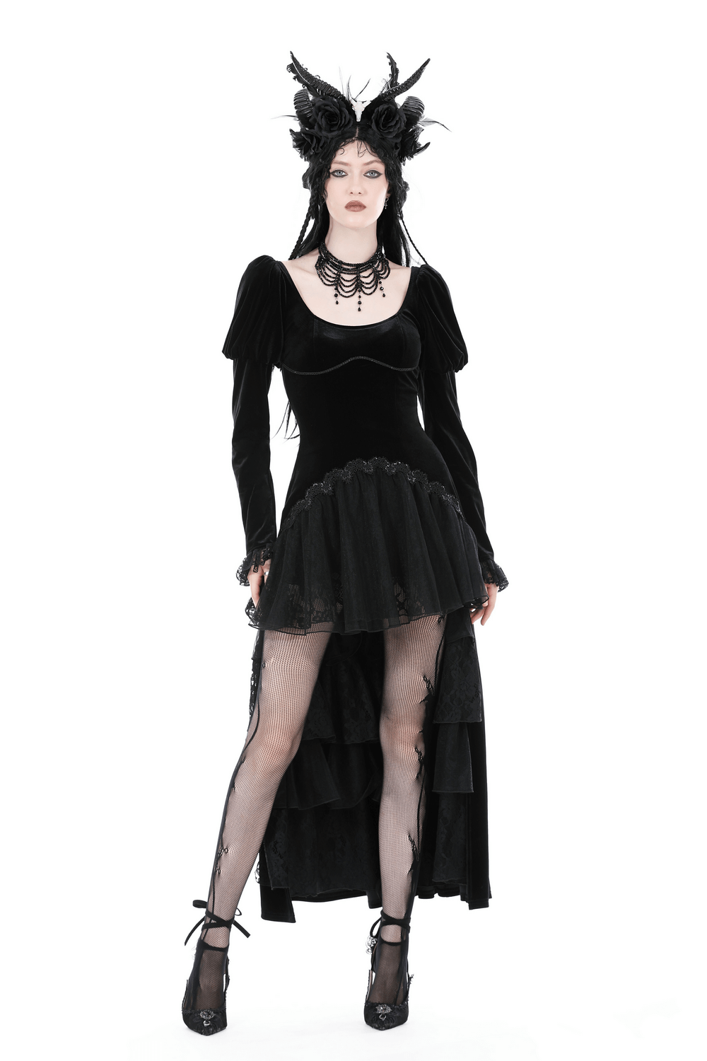 Women’s black velvet gothic high-low dress with lace hem, ruffle neckline, and statement accessories.
