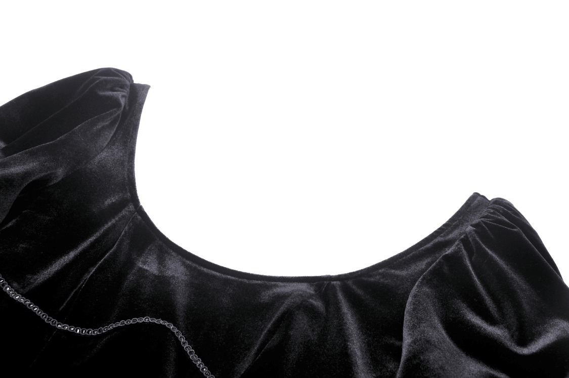 Close-up of the ruffled neckline of a women's black velvet gothic dress, showcasing luxurious fabric and intricate details.