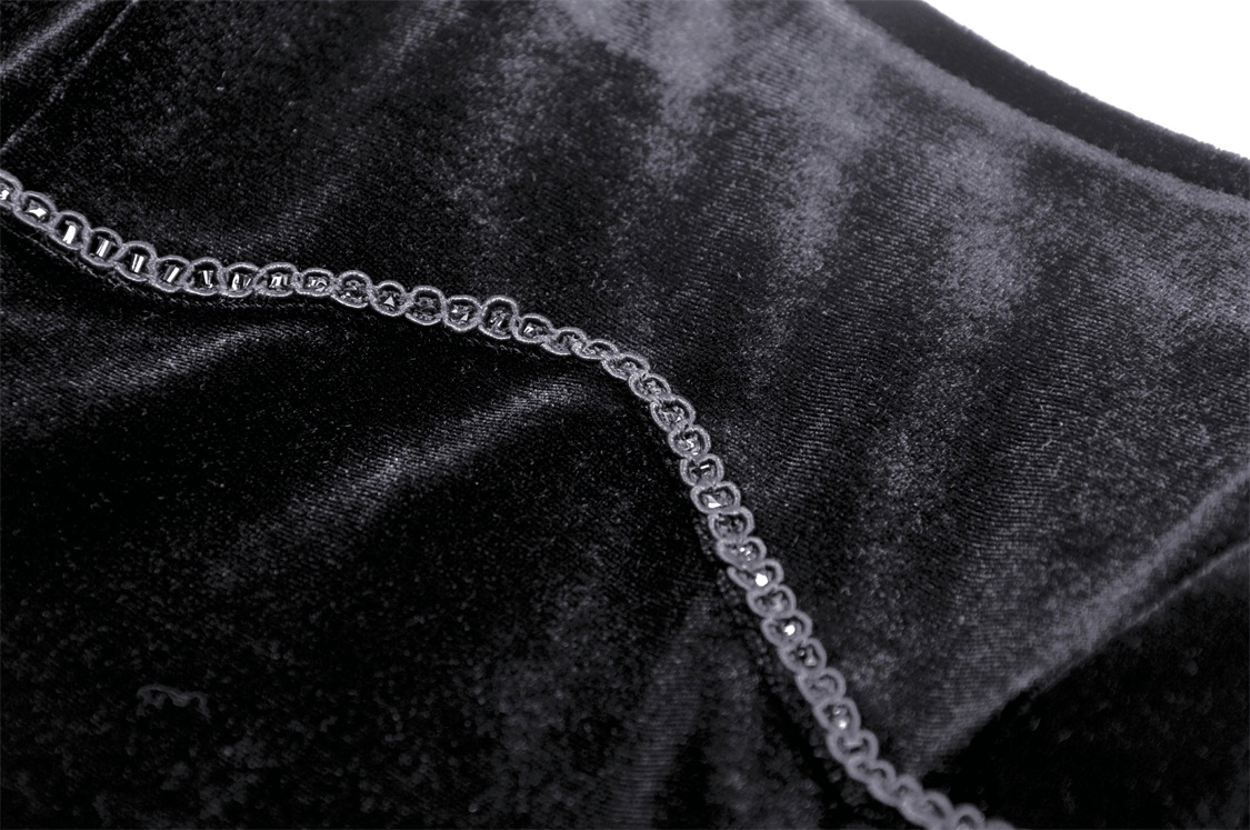 Close-up of luxurious black velvet fabric with intricate beaded detailing, perfect for gothic elegance.