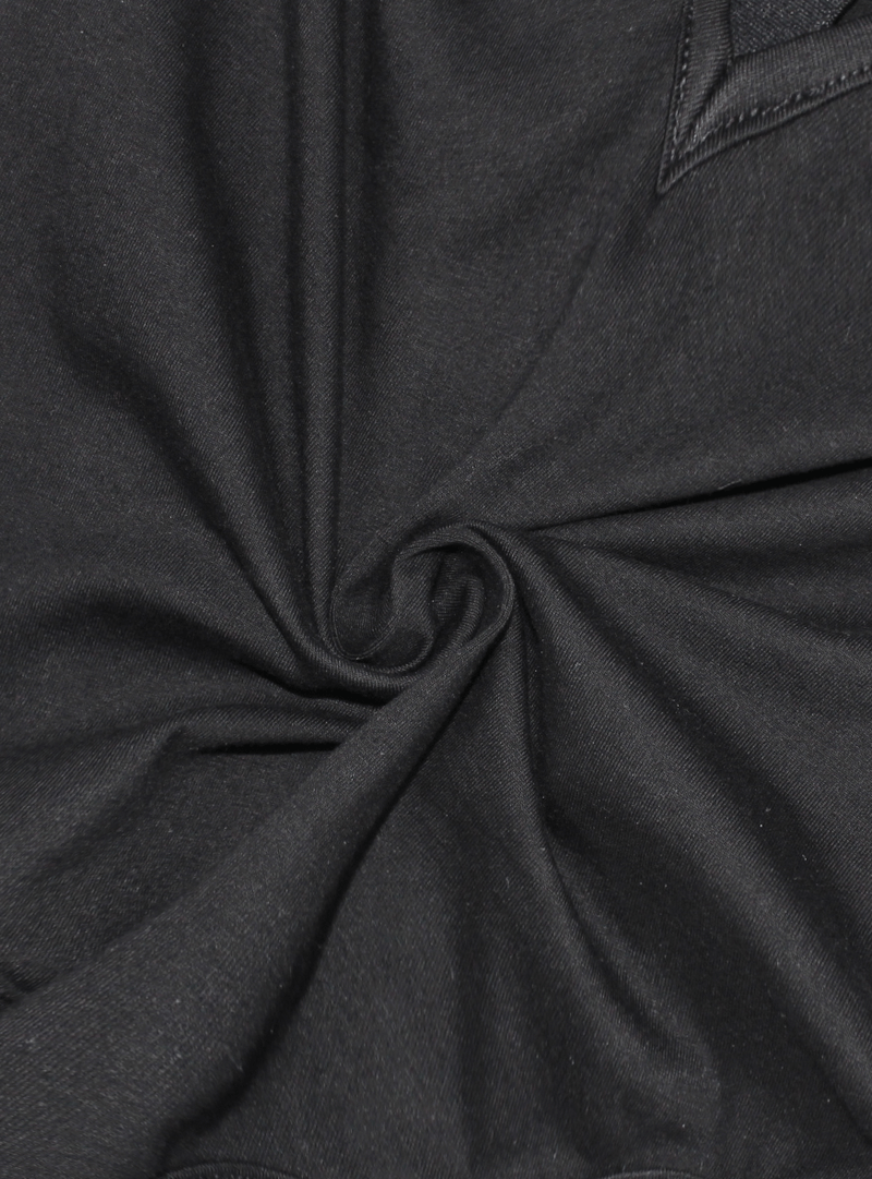 Close-up of soft black fabric, showing texture and swirl detail for women's punk bodysuit.