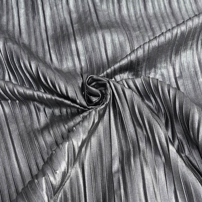 Close-up of bright silver shimmer fabric featuring a pleated texture, perfect for a stylish women's cyberpunk blouse.