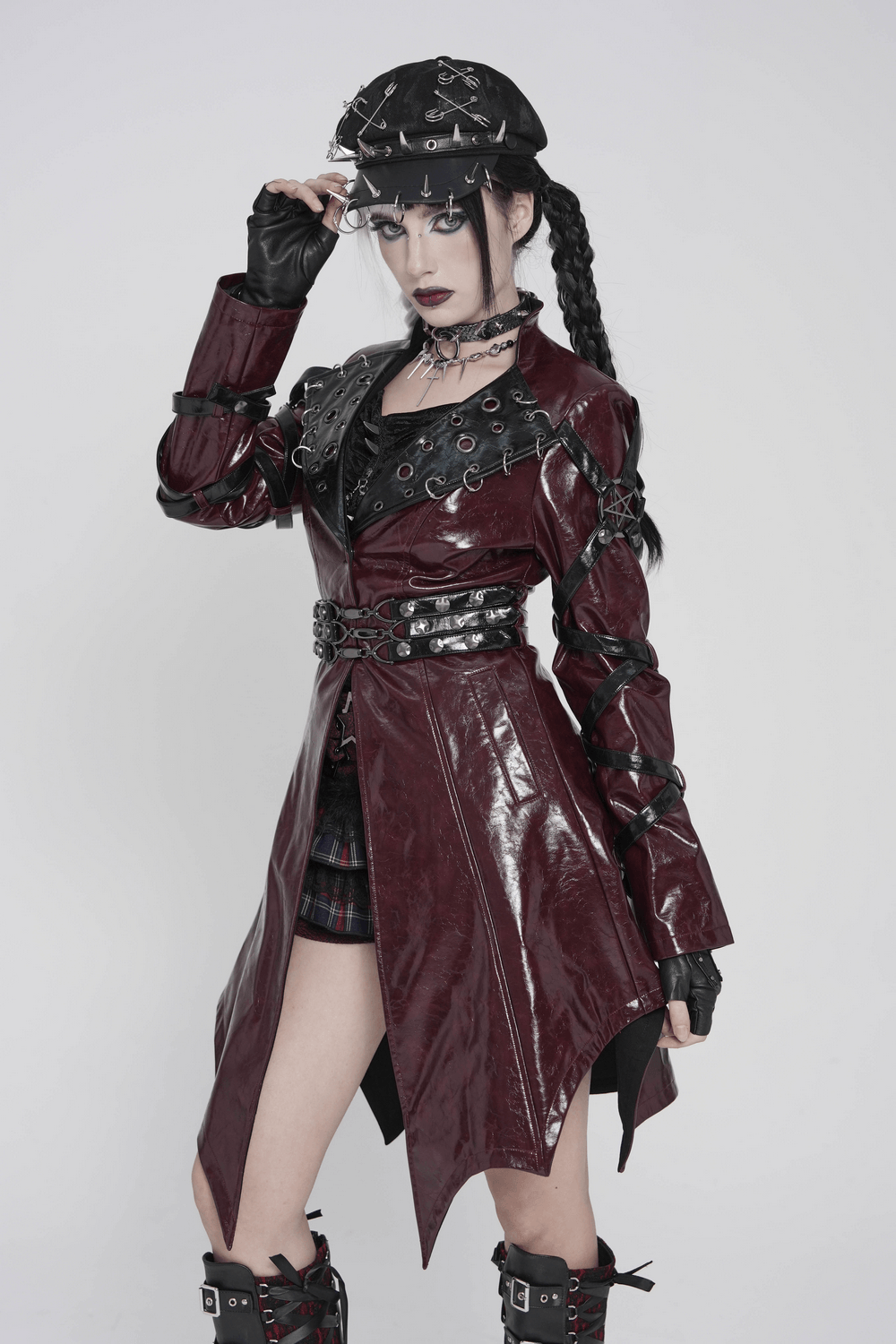 Women's Burgundy Faux Leather Harness Long Coat featuring glossy faux leather and striking buckle details.