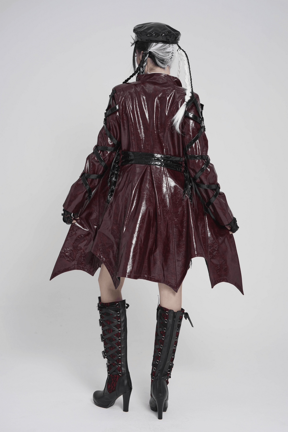 Women's Burgundy Faux Leather Harness Long Coat showcasing a glossy finish and dramatic asymmetric hem.