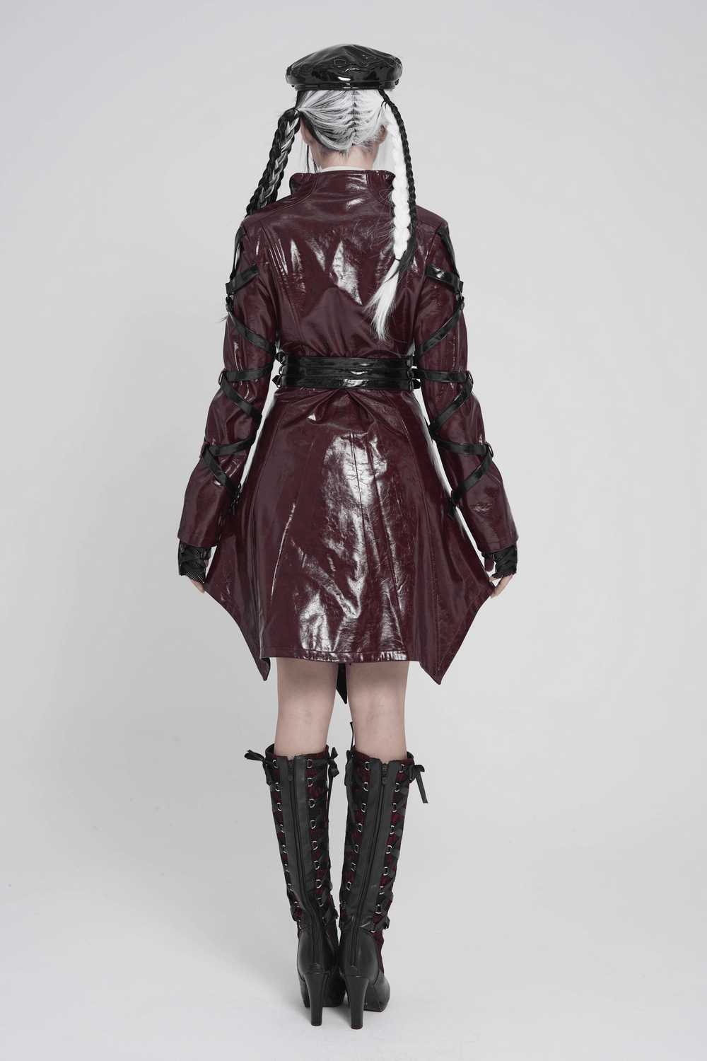 Women's Burgundy Faux Leather Harness Long Coat with dramatic wrap detailing and stylish knee-high boots.