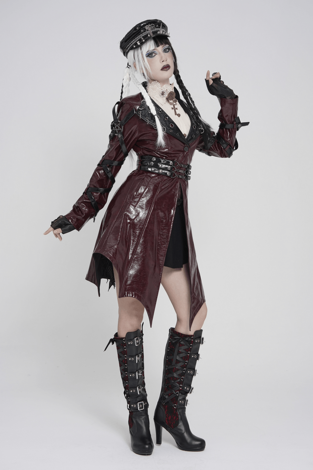 Women's Burgundy Faux Leather Harness Long Coat worn by model with edgy styling and dramatic accessories.