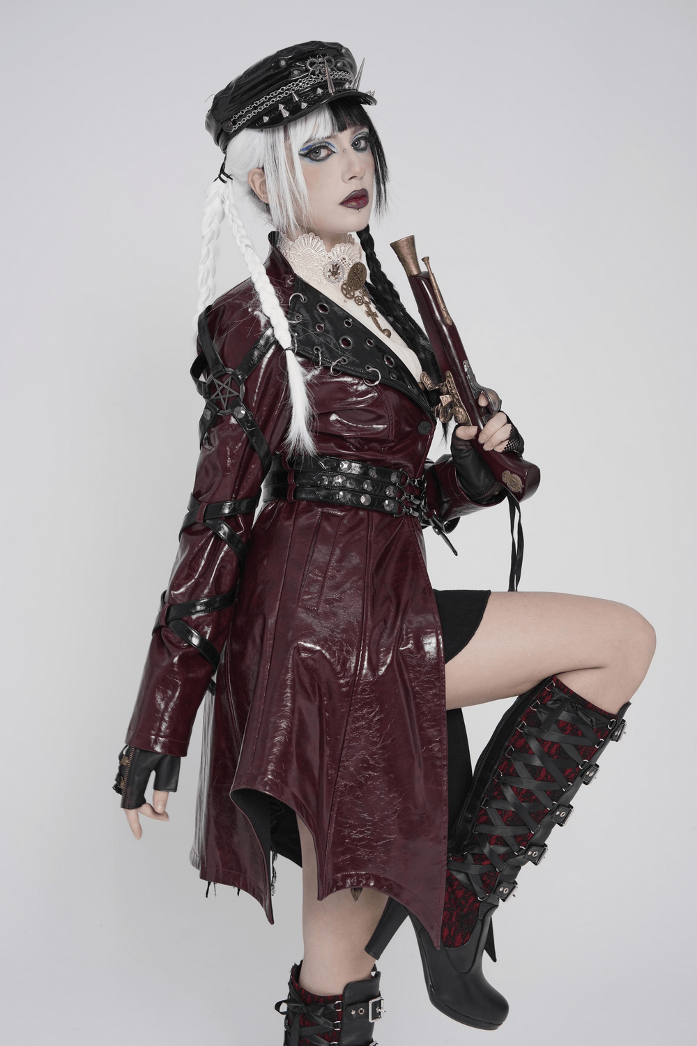 Women's Burgundy Faux Leather Harness Long Coat showcased with gothic accessories and striking styling.
