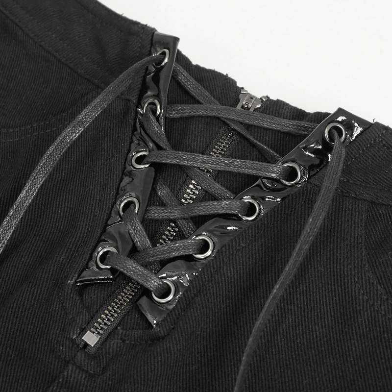 Close-up of women's punk style lace-up front zipper shorts with chain accents and ripped details.