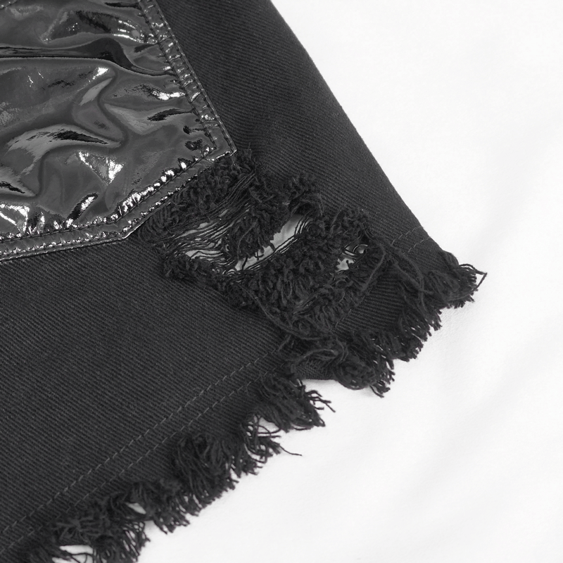 Close-up of women's punk style chains ripped shorts with frayed edges and glossy accents.