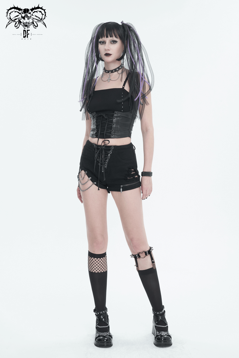 Punk-style woman in chains ripped shorts with lace-up pockets and front zipper, paired with a black top and edgy accessories.