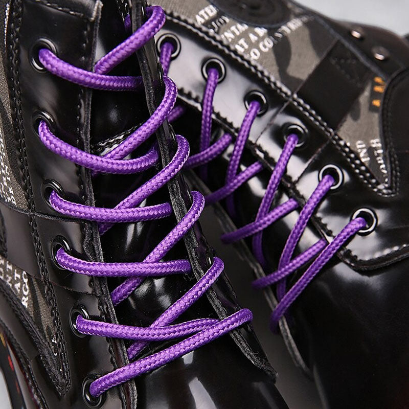 Close-up of women's chunky short boots featuring bold purple laces and a stylish mix of patterns and textures.