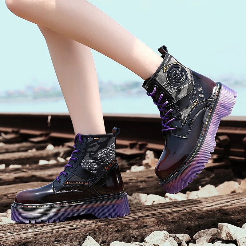 Stylish women's chunky ankle boots in black with purple accents and fun patches, perfect for alternative fashion looks.