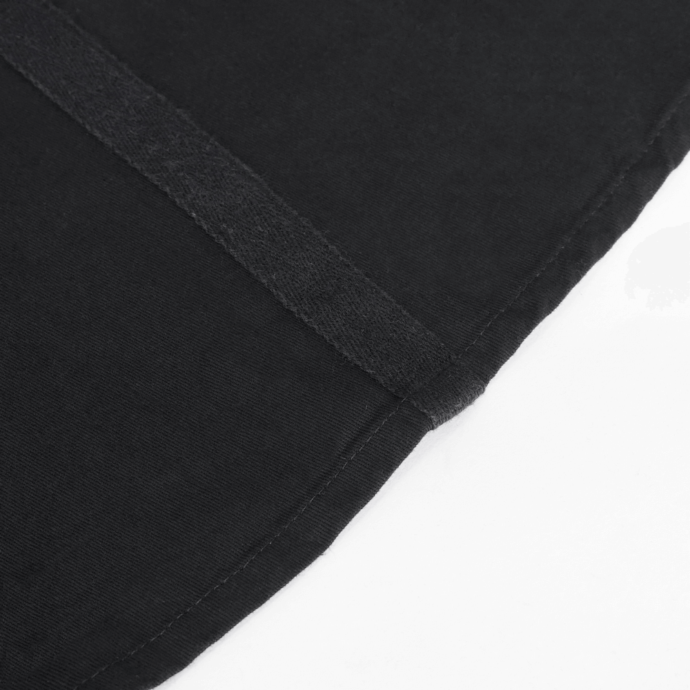 Close-up of the hem of a stylish women's black cotton long skirt with intricate seam details.