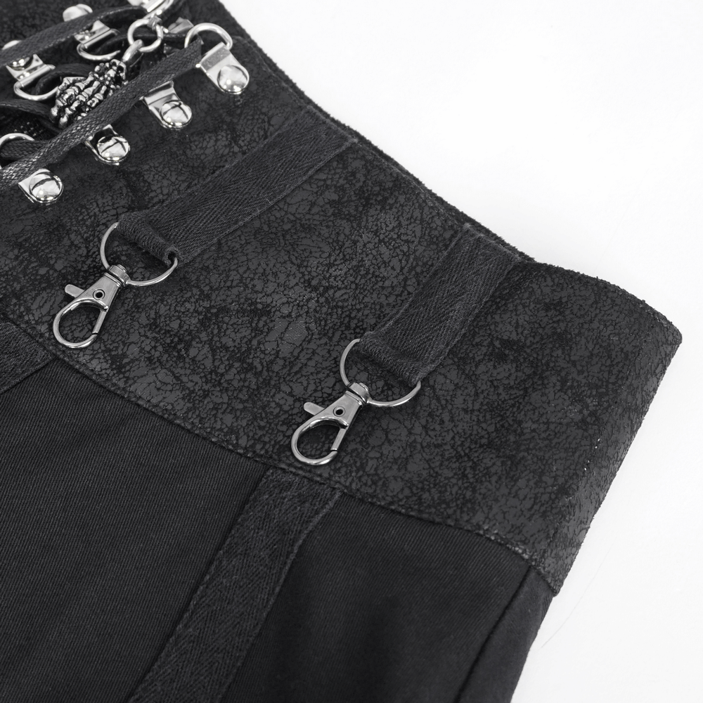 Close-up of women's steampunk black skirt showing unique metal clips and intricate layered design.