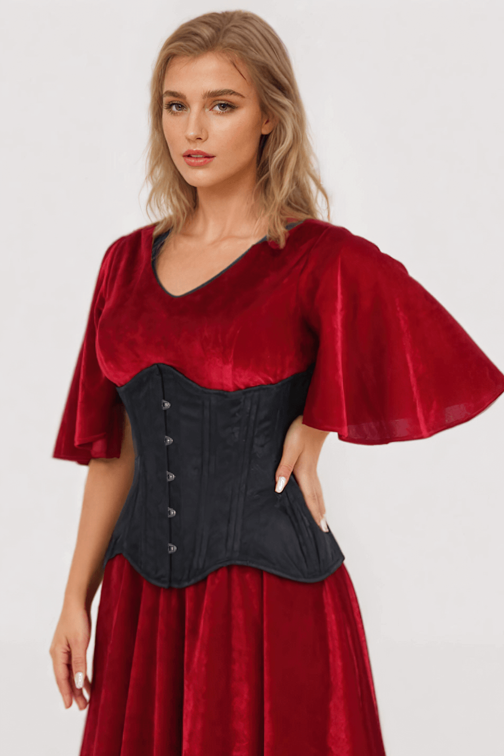 Woman modeling a red dress with a black brocade waist trainer corset for a stylish silhouette.