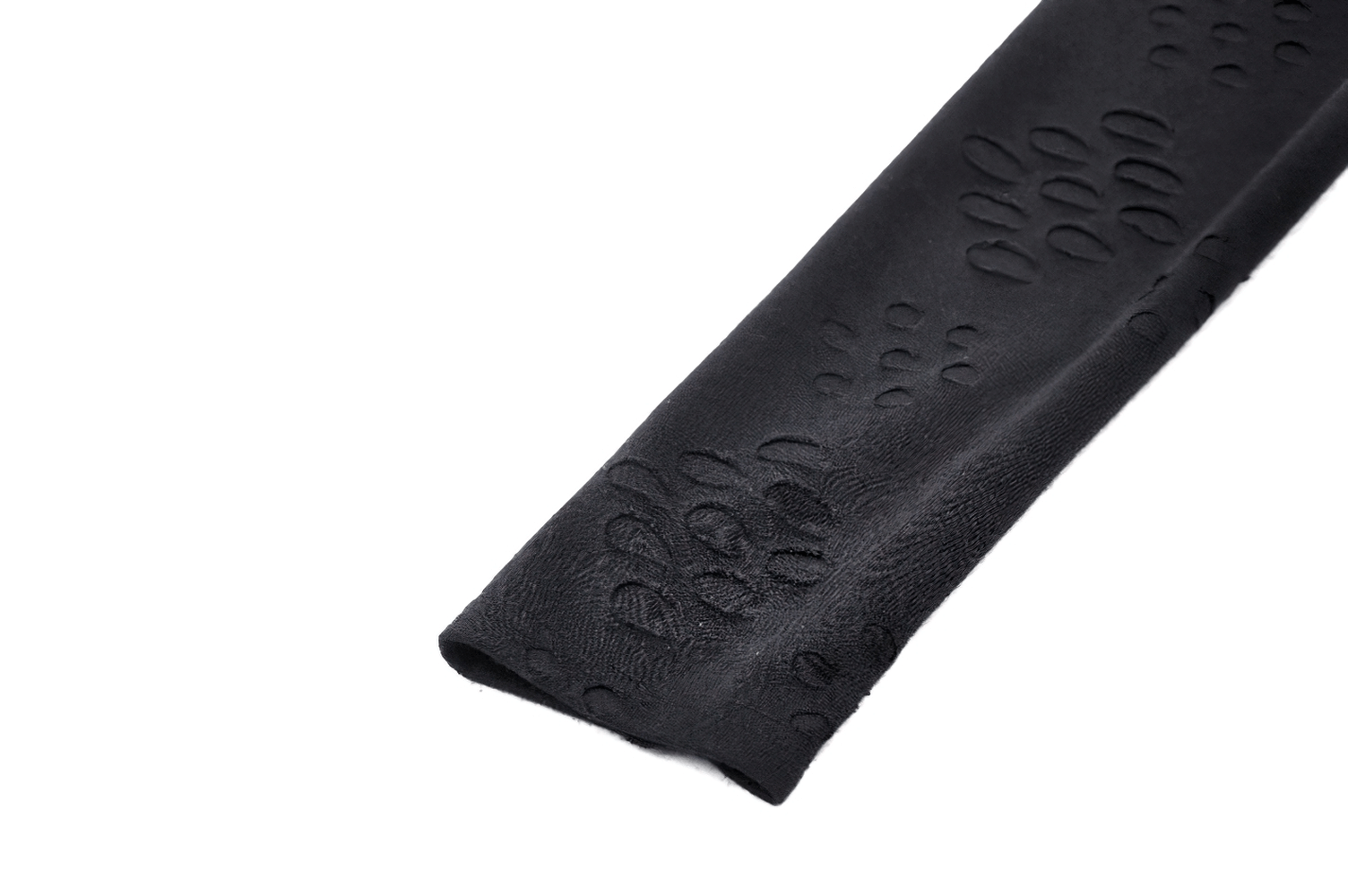 Close-up of black textured leather fabric with embossed patterns, showcasing a unique design ideal for edgy fashion pieces.