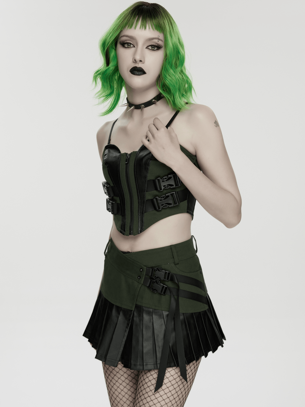 Women's Cyberpunk Buckle Bustier Corset Crop Top worn with a stylish skirt, showcasing a bold dark streetwear look.