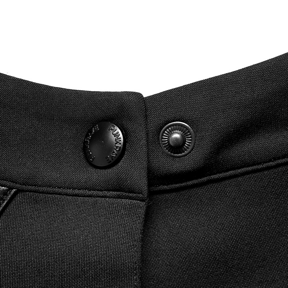 Close-up of black pants showing stylish button details and sleek fabric texture for an edgy look.