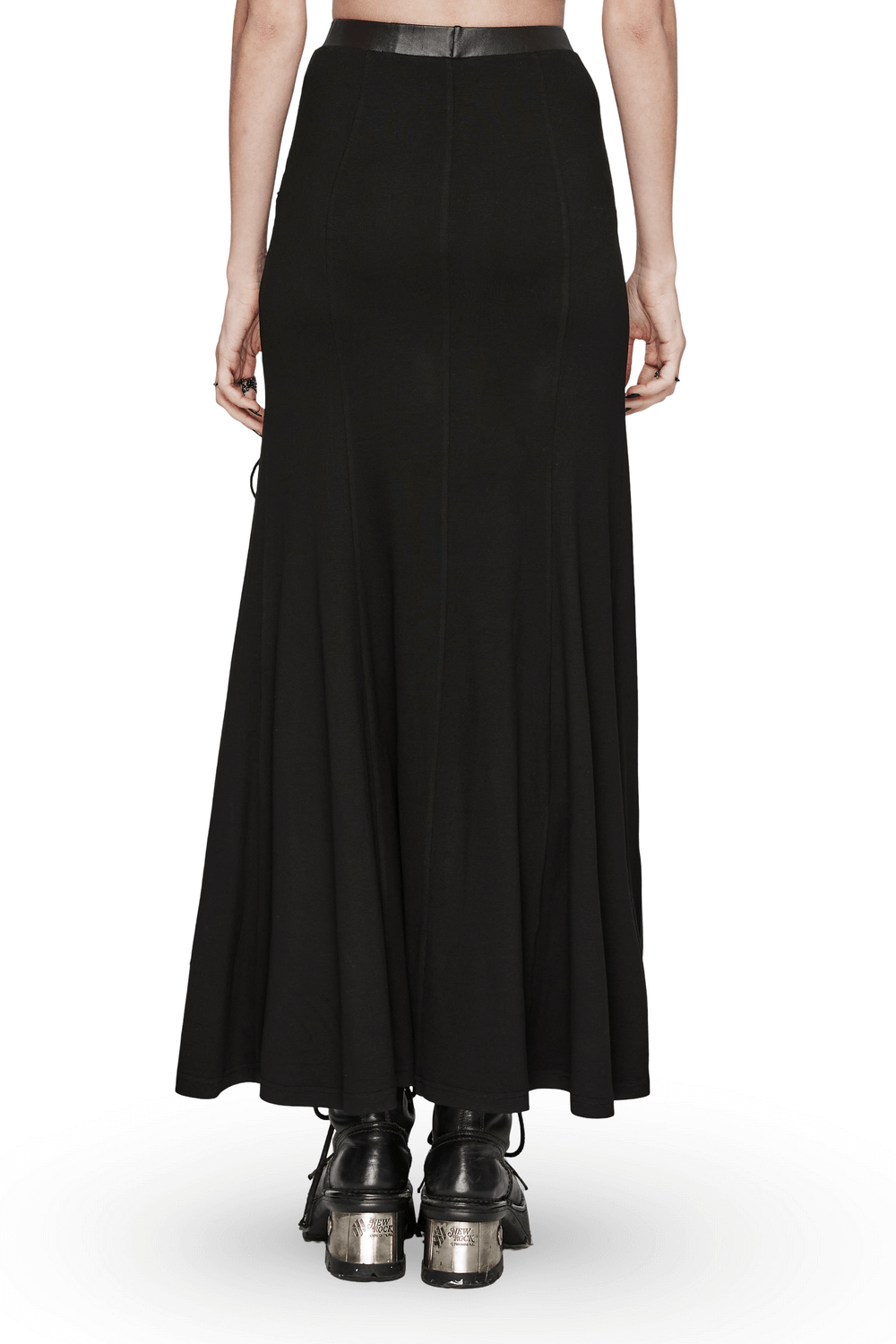 Back view of women's edgy black skirt with mesh slits and drawstrings, paired with stylish boots.