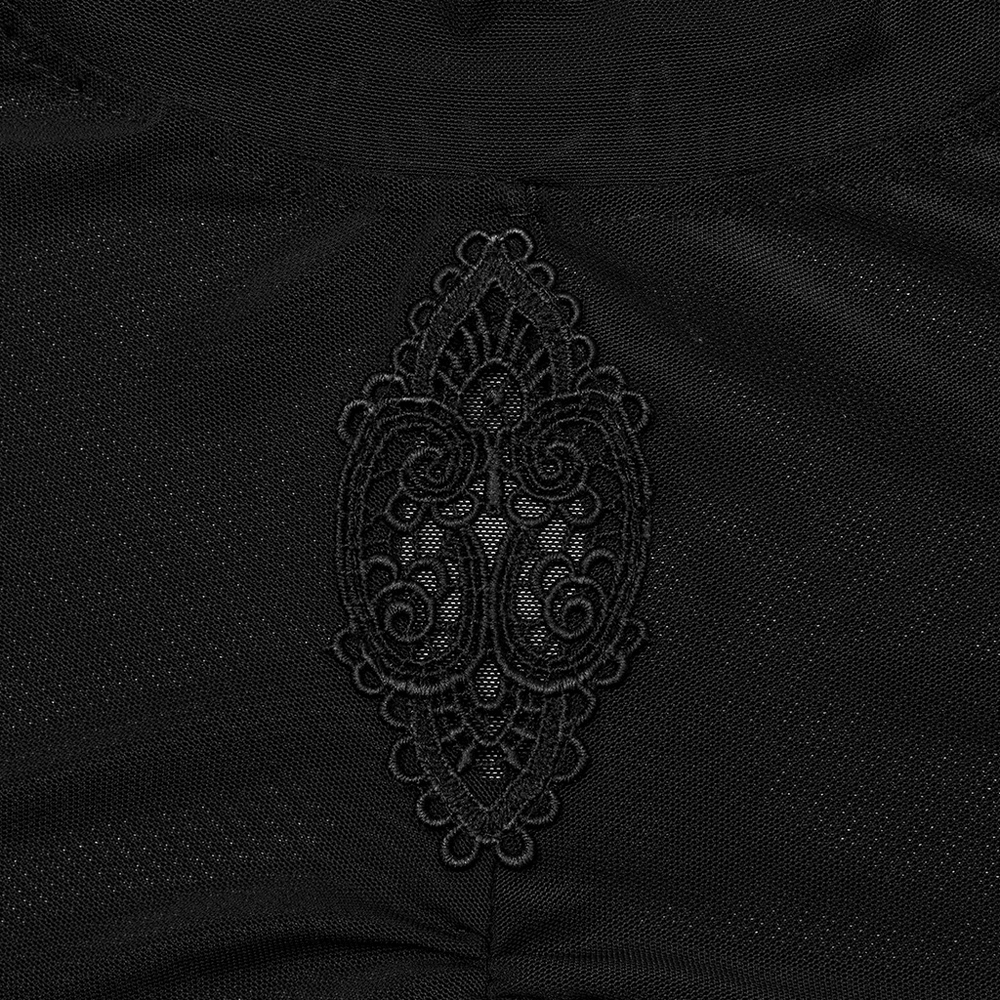 Close-up of intricate embroidered accent on gothic black mesh top, showcasing elegant design and texture.