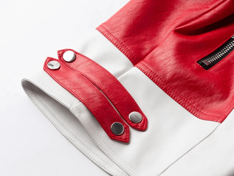 Close-up of the cuff of a women's faux leather biker jacket, featuring stylish red and white design elements.
