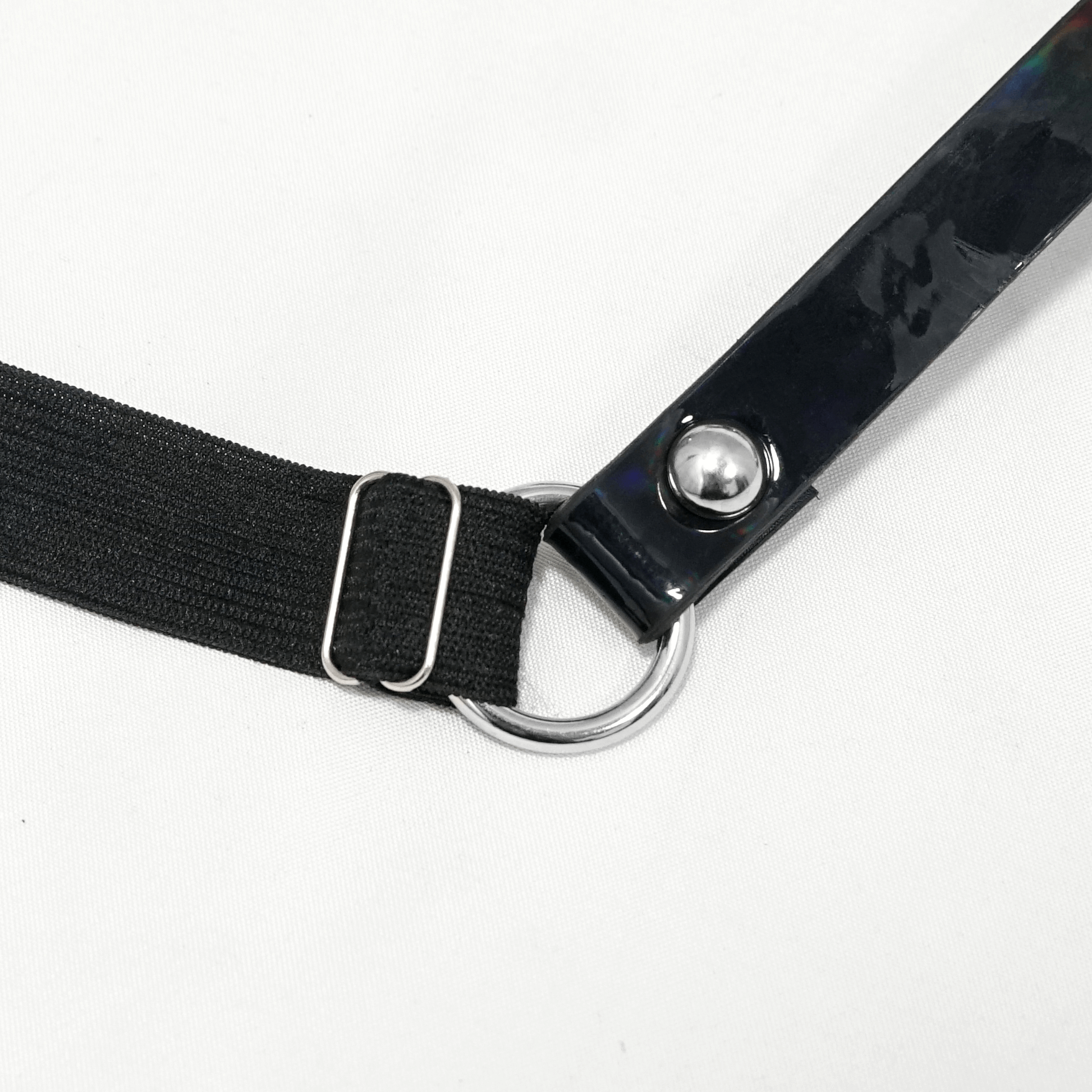 Close-up of adjustable black faux leather body harness with silver fittings, perfect for gothic and cosplay styles.